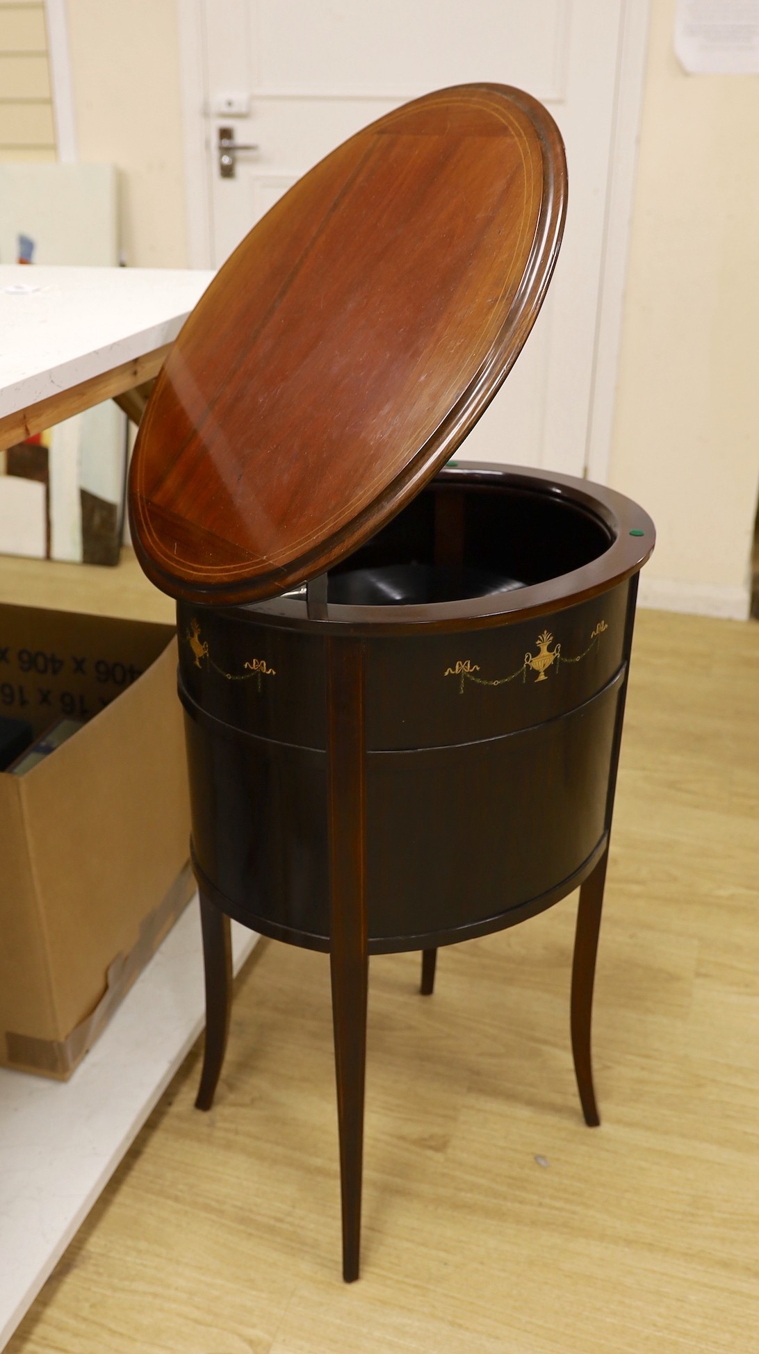 An early 20th century Tyrela parlour gramophone, in an oval mahogany table cabinet, 51 cm wide, 77 cm high